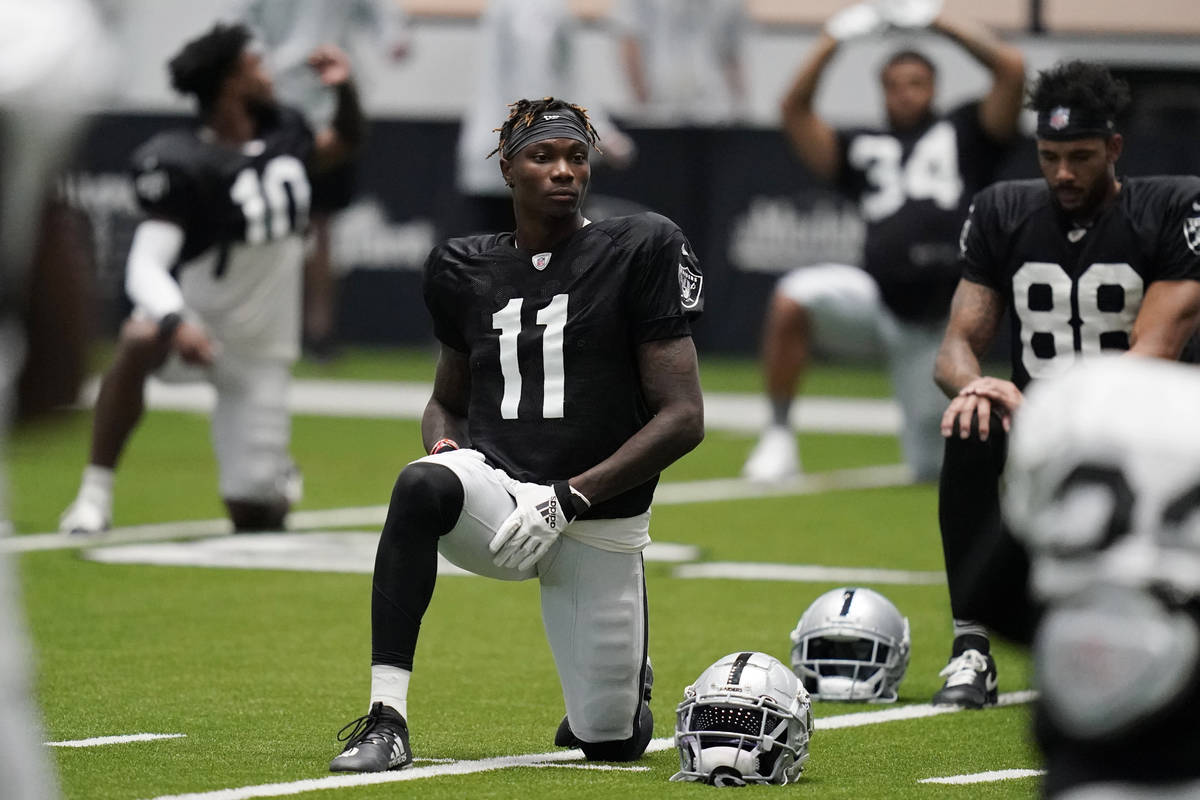 Las Vegas Raiders wide receiver Henry Ruggs III (11) stretches during an NFL football training ...