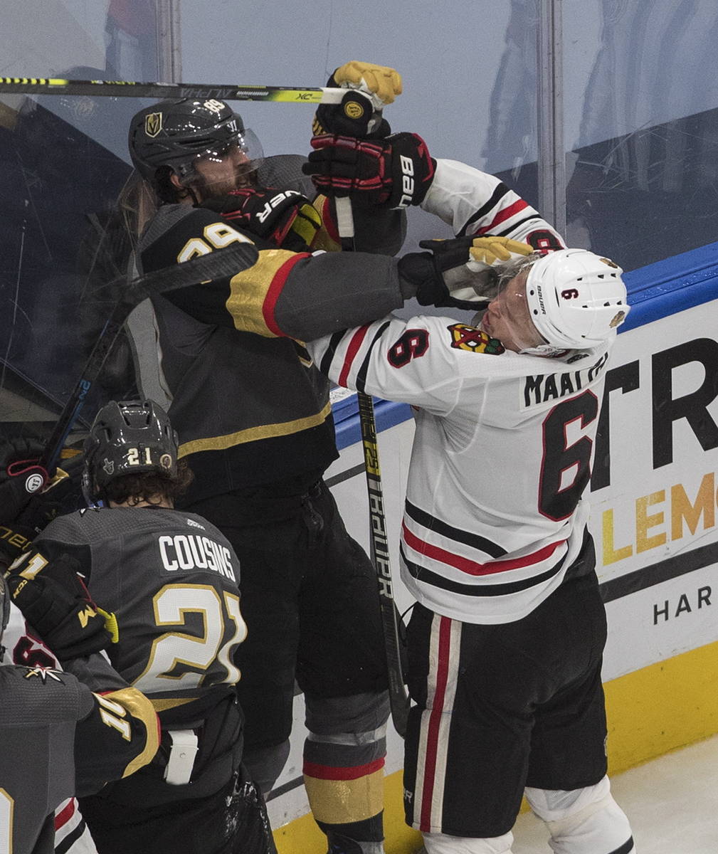Vegas Golden Knights' Alex Tuch (89) and Chicago Blackhawks' Olli Maatta (6) rough it up during ...