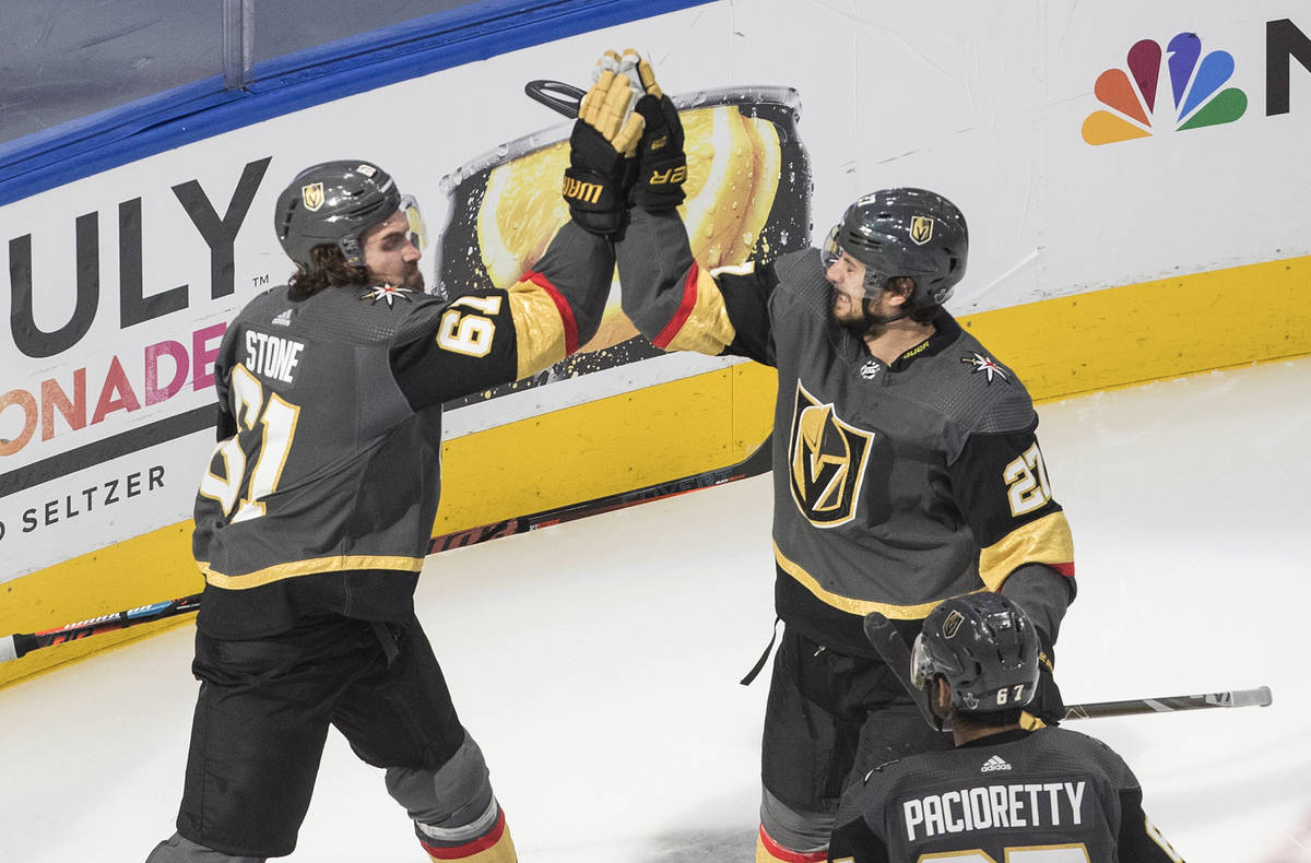 Vegas Golden Knights' Mark Stone (61) and Shea Theodore (27) celebrate a goal against the Chica ...