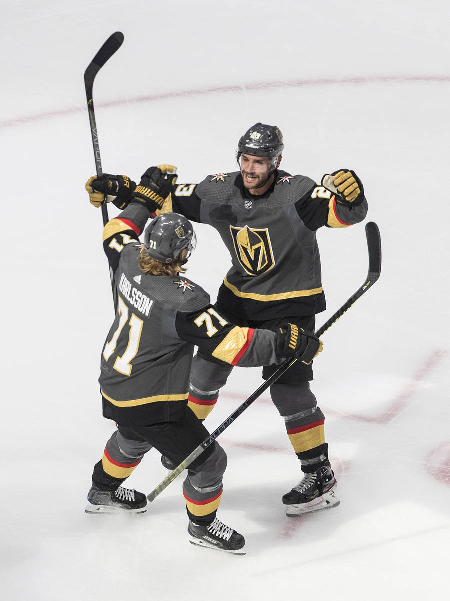 Vegas Golden Knights' Alec Martinez (23) and William Karlsson (71) celebrate a goal against the ...