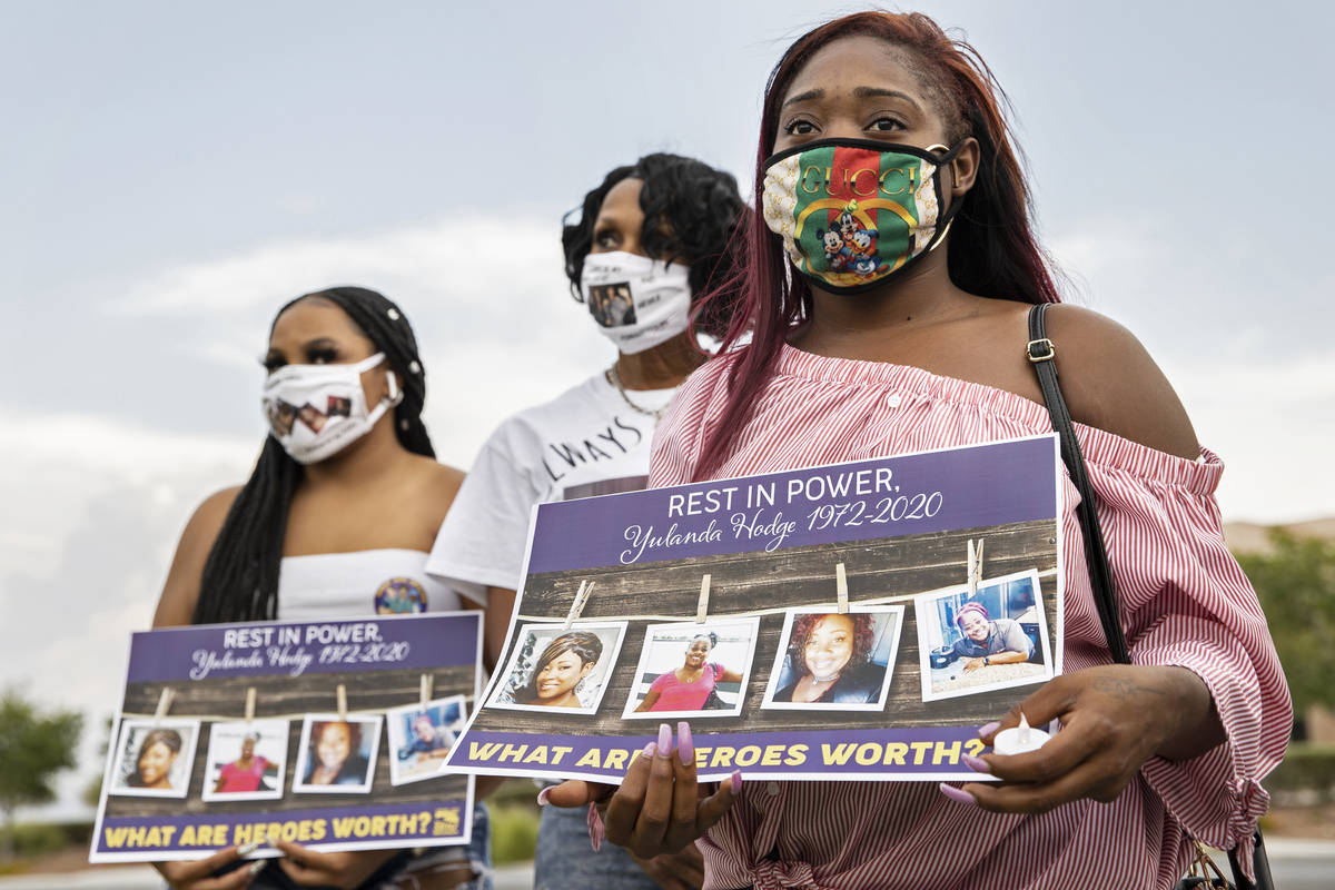 Dejanae Brown, 23, the daughter of food service worker Yulanda Hodge, listens to a speaker duri ...