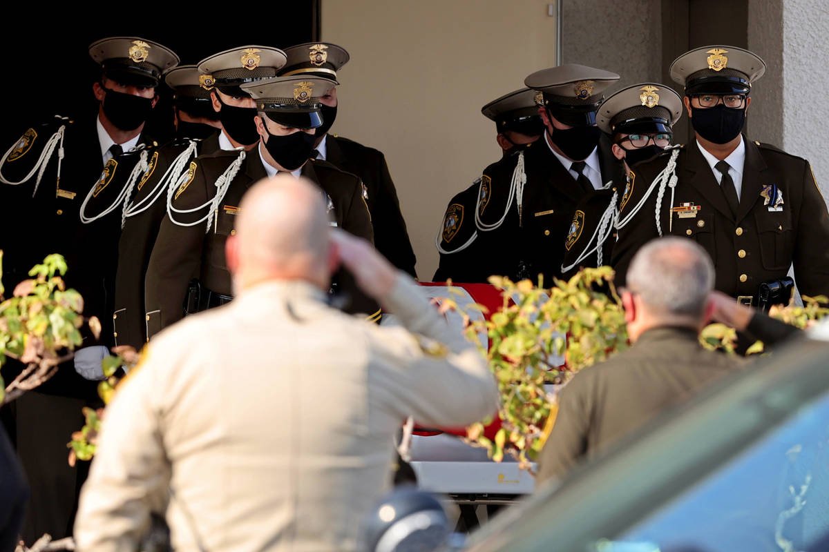 Honor guard members load the casket of Metropolitan Police Department Lt. Erik Lloyd at Palm Do ...