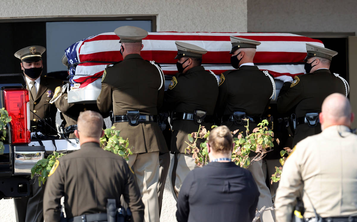 Honor guard members load the casket of Metropolitan Police Department Lt. Erik Lloyd at Palm Do ...