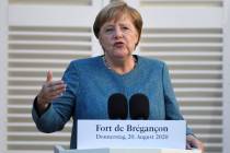 German Chancellor Angela Merkel speaks during a press conference with French President Emmanuel ...
