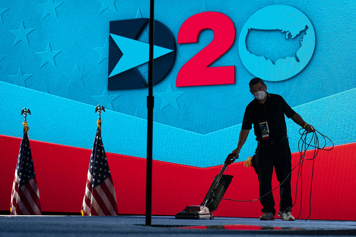A worker vacuums the stage where Democratic vice presidential candidate Sen. Kamala Harris, D-C ...