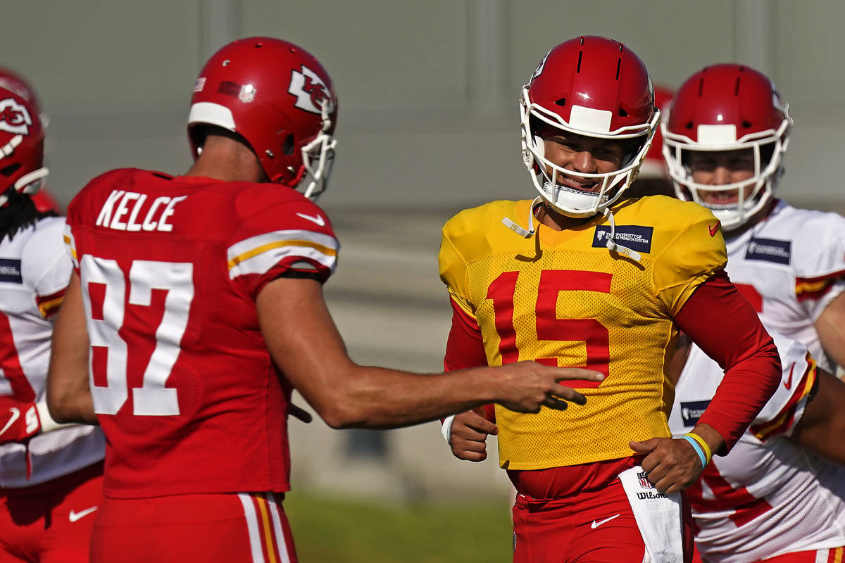 Kansas City Chiefs quarterback Patrick Mahomes (15) and tight end Travis Kelce (87) talk during ...