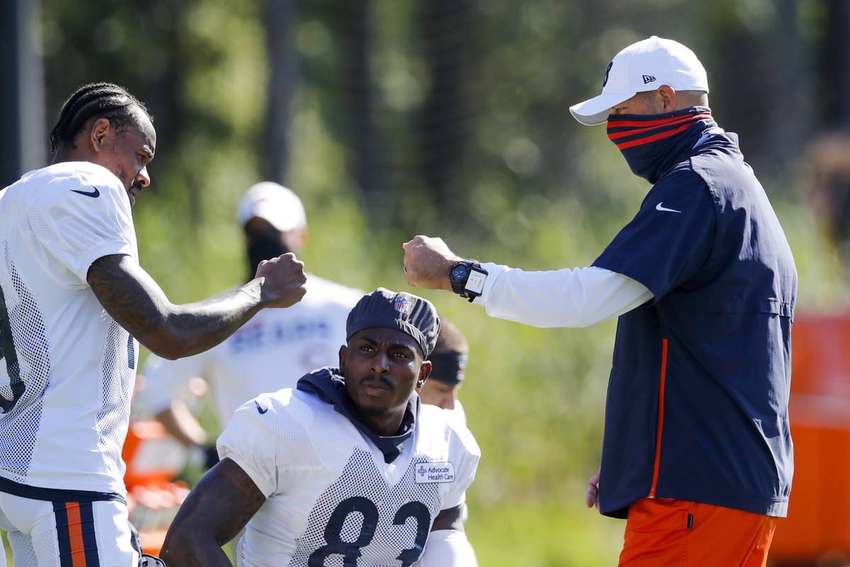 Chicago Bears head coach Matt Nagy fist bumps Chicago Bears wide receiver Ted Ginn Jr. (19), le ...