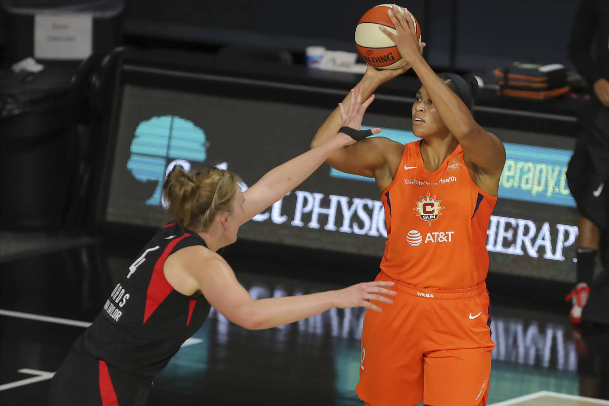 Connecticut Sun's Brionna Jones, right, shoots over Las Vegas Aces' Carolyn Swords during the f ...