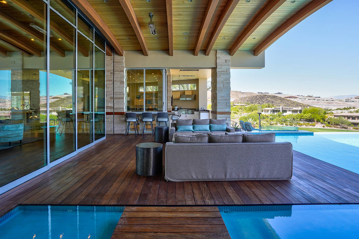 The pool surrounds the backyard patio. (Sun West Custom Homes)