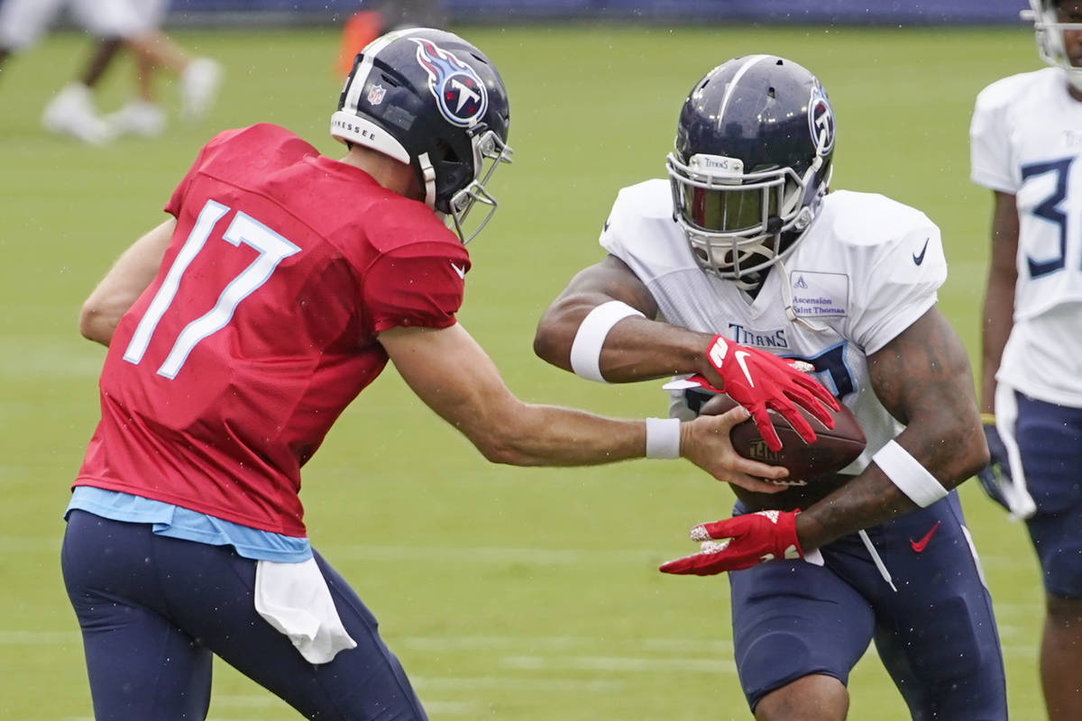 Tennessee Titans quarterback Ryan Tannehill (17) hands off to running back Derrick Henry during ...