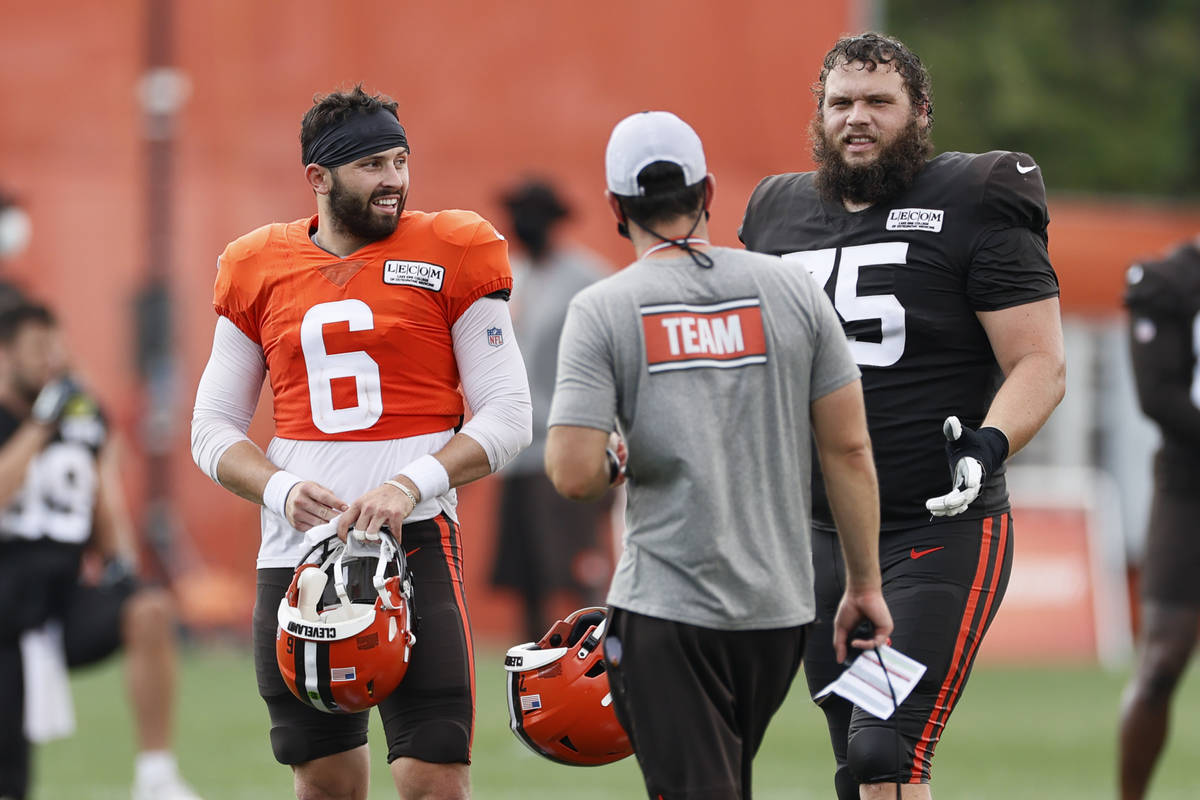 Cleveland Browns quarterback Baker Mayfield (6) and guard Joel Bitonio (75) talk with head coac ...