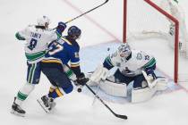 St. Louis Blues David Perron (57) is stopped by Vancouver Canucks goalie Jacob Markstrom (25) a ...
