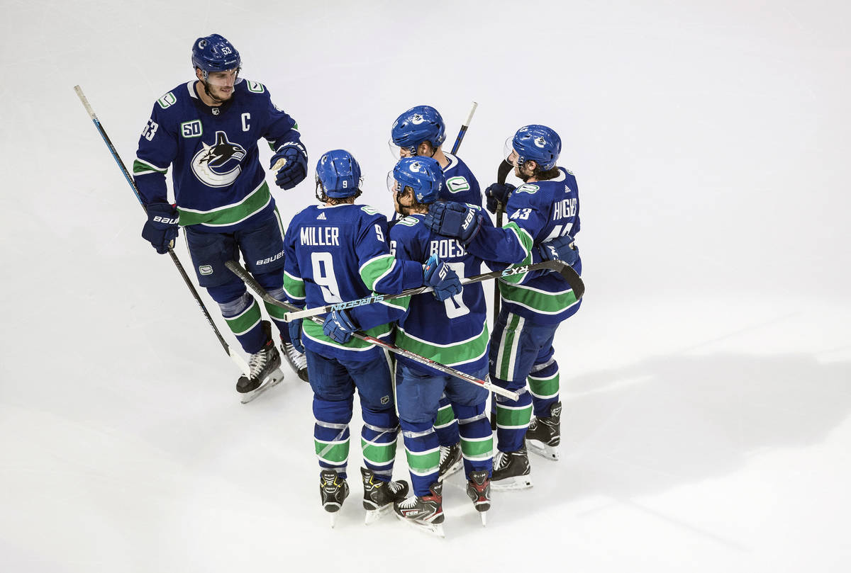 Vancouver Canucks celebrate a goal against the St. Louis Blues during second-period NHL Western ...
