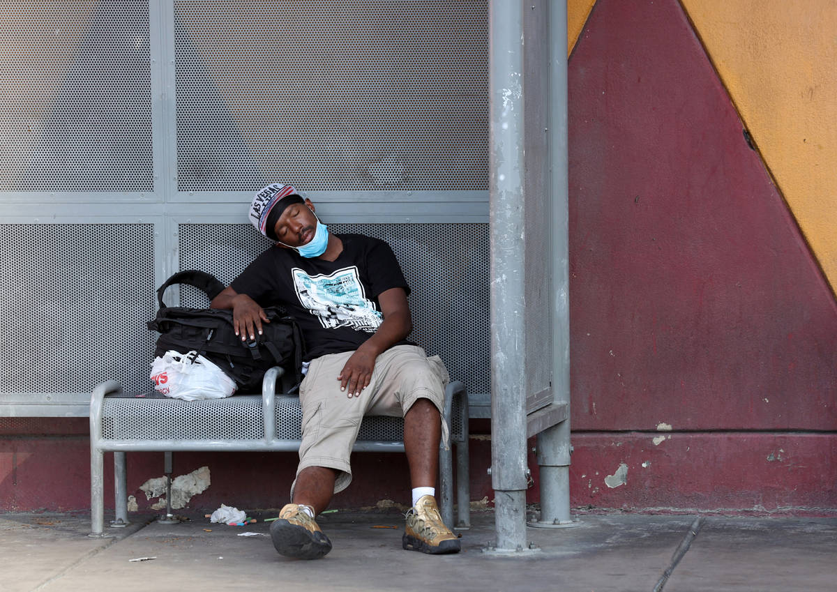 A person rests in the shade on Las Vegas Boulevard near Fremont Street Monday, Aug. 17, 2020. ( ...