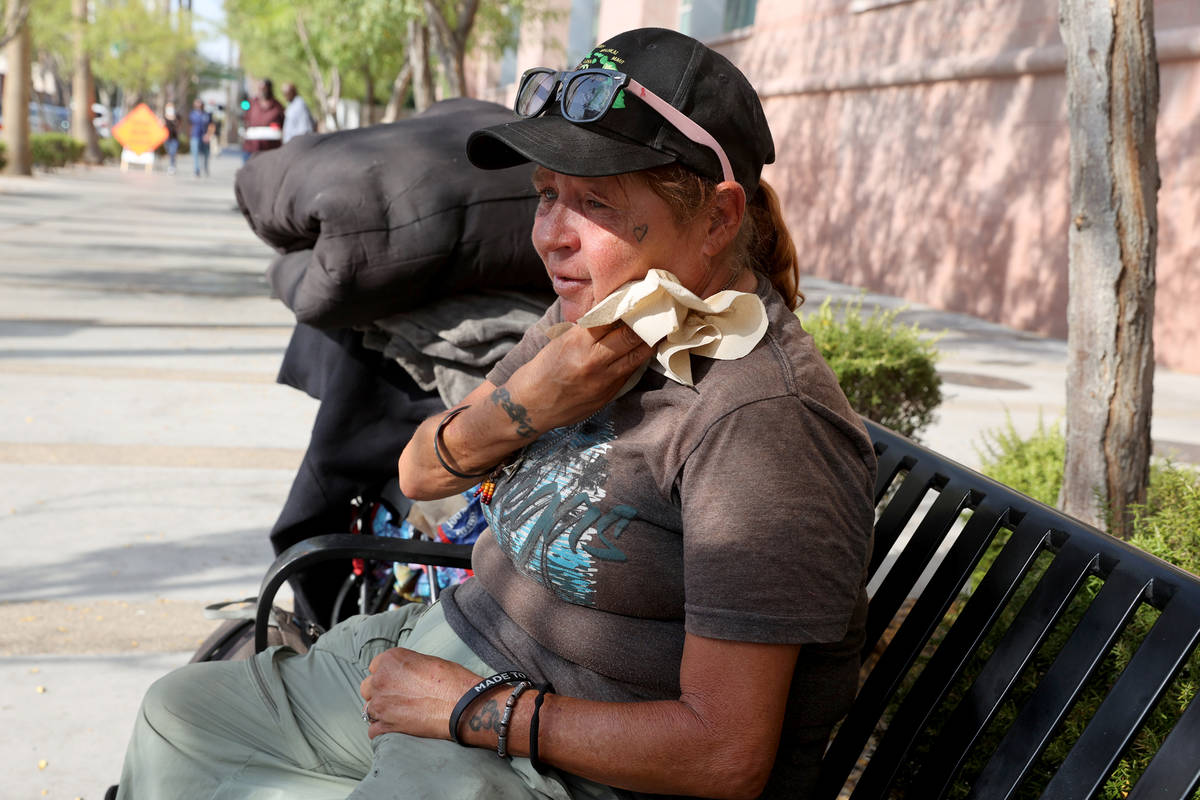 Alice "Allie" Patz wipes sweat on 3rd Street in front of the Regional Justice Center ...