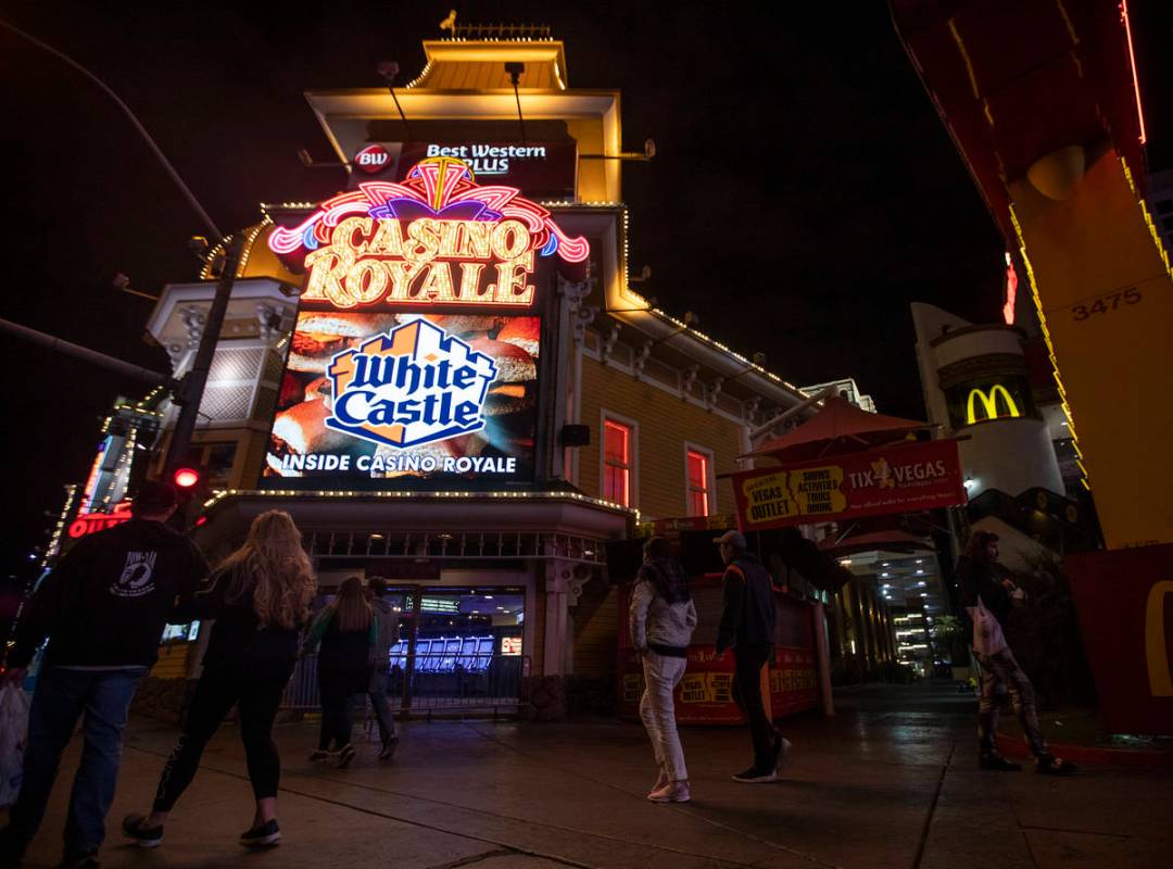 People walk past Casino Royale on the Strip on Tuesday, March 17, 2020, in Las Vegas. (Ellen Sc ...