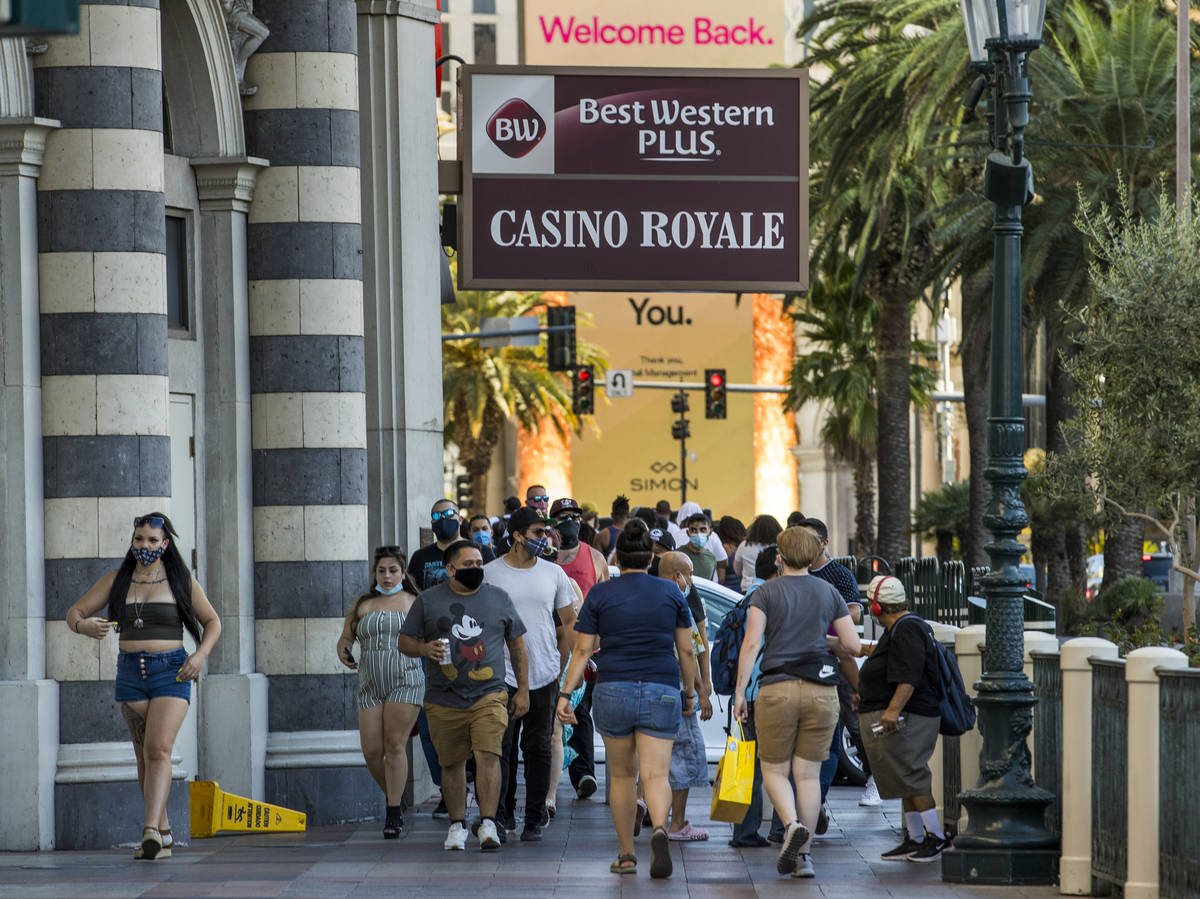 Visitors wander about the Casino Royale along the Strip on Friday, August 7, 2020, in Las Vegas ...