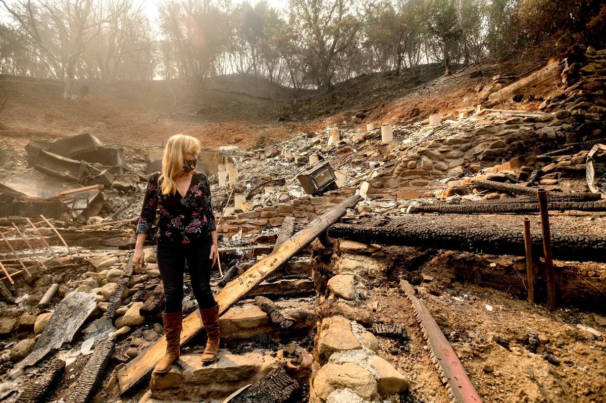 Pam, who declined to give a last name, examines the remains of her partner's Vacaville, Calif., ...