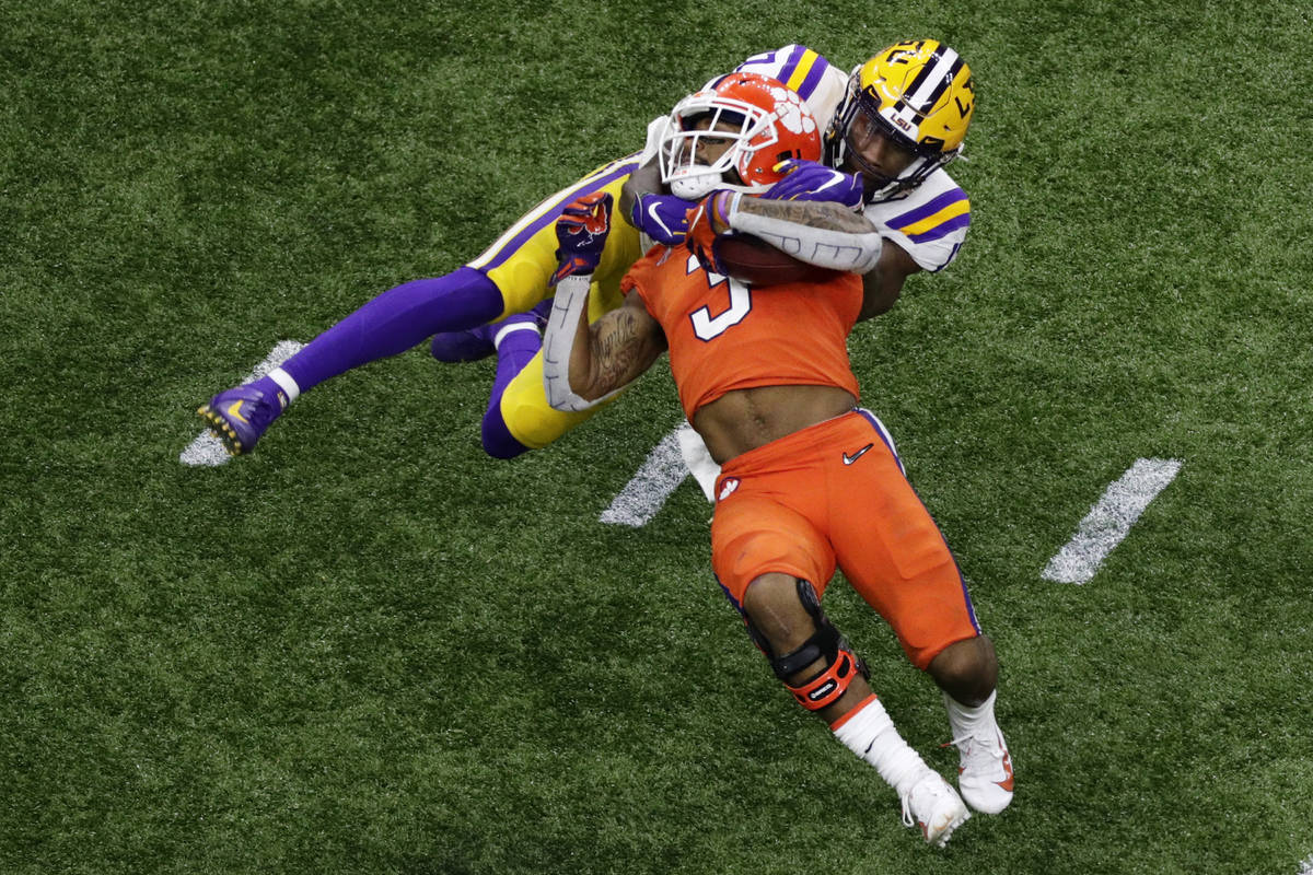Clemson wide receiver Amari Rodgers is tackled by LSU's Racey McMath during the second half of ...