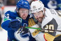 Vancouver Canucks defenseman Quinn Hughes (43) vies for control of the puck with Vegas Golden K ...
