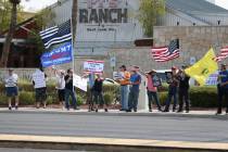 People attend a No Mask Nevada PAC rally at the intersection of Eastern Avenue and Pebble Road ...