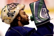 Vancouver Canucks goalie Roberto Luongo has a sip of water during a break in practice in Vancou ...