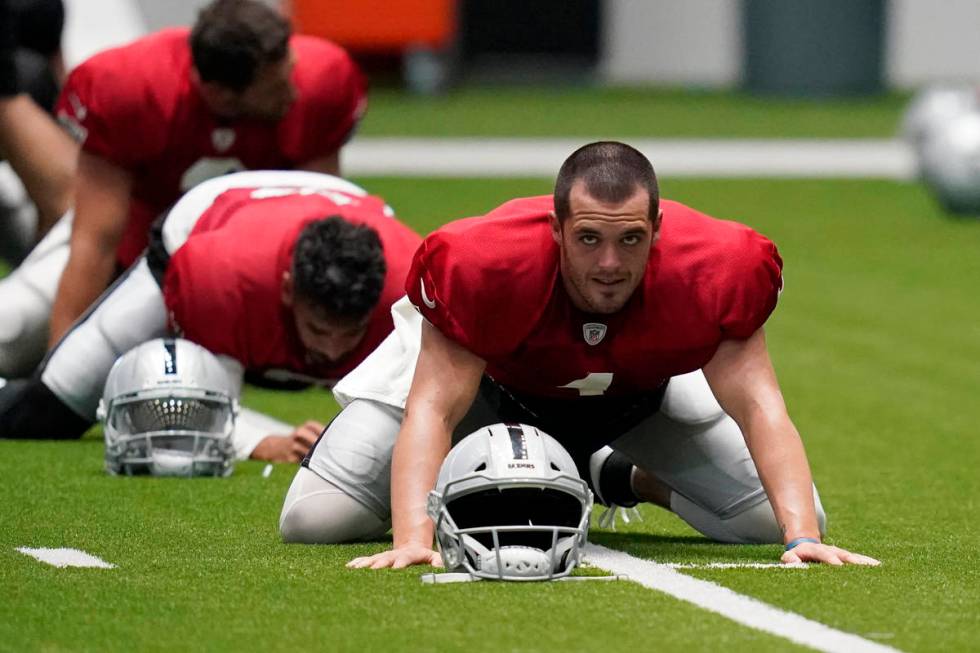Las Vegas Raiders quarterback Derek Carr (4) stretches during an NFL football training camp pra ...