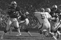 George Atkinson of the Oakland Raiders breaks inside Mike Simone of the Denver Broncos as he re ...