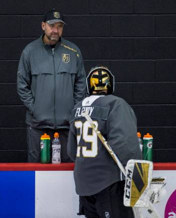 Vegas Golden Knights head coach Peter DeBoer listens to goaltender Marc-Andre Fleury (29) duri ...