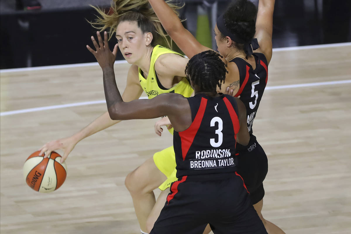 Seattle Storm's Breanna Stewart tries to break through the defense of Las Vegas Aces' Danielle ...