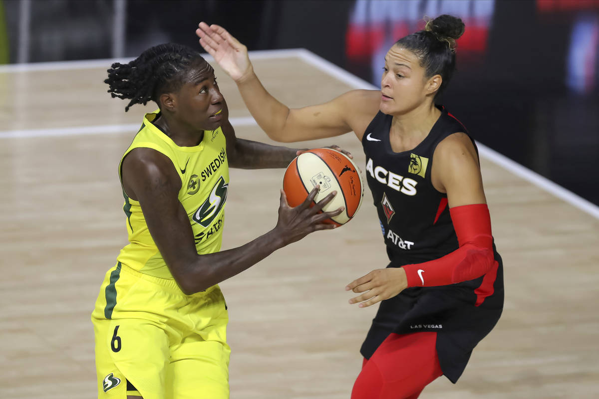 Seattle Storm's Natasha Howard (6) attempts to drive past the defense of Las Vegas Aces' Kayla ...