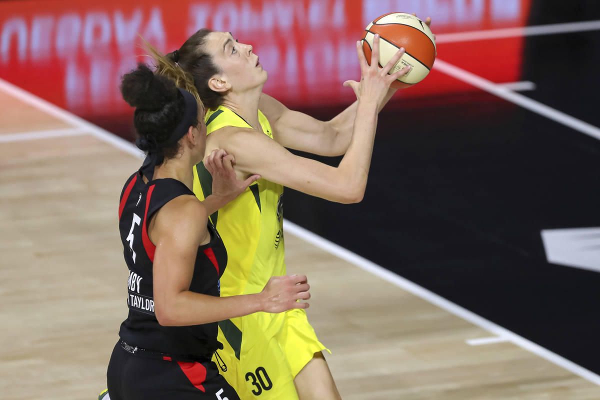 Seattle Storm's Breanna Stewart, right, shoots past the defense of Las Vegas Aces' Dearica Hamb ...