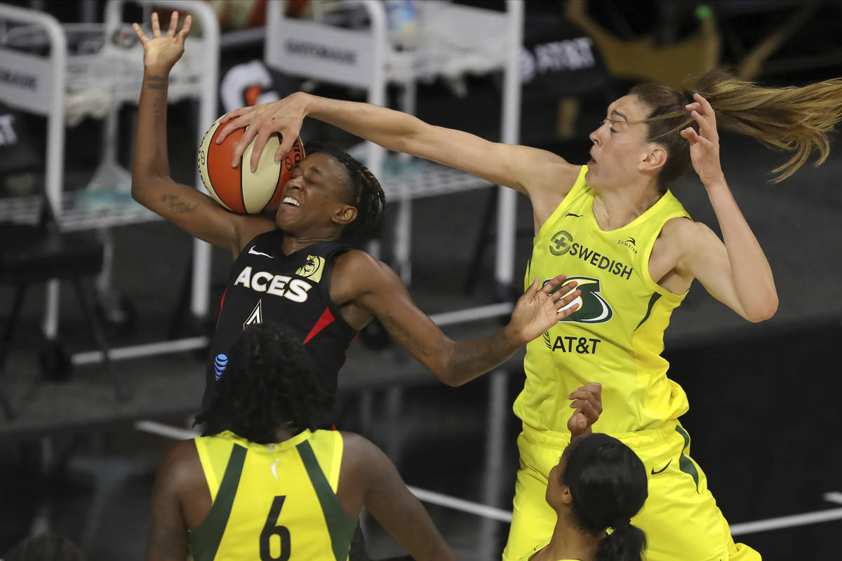 Seattle Storm's Breanna Stewart, right, blocks a shot-attempt by Las Vegas Aces' Danielle Robin ...