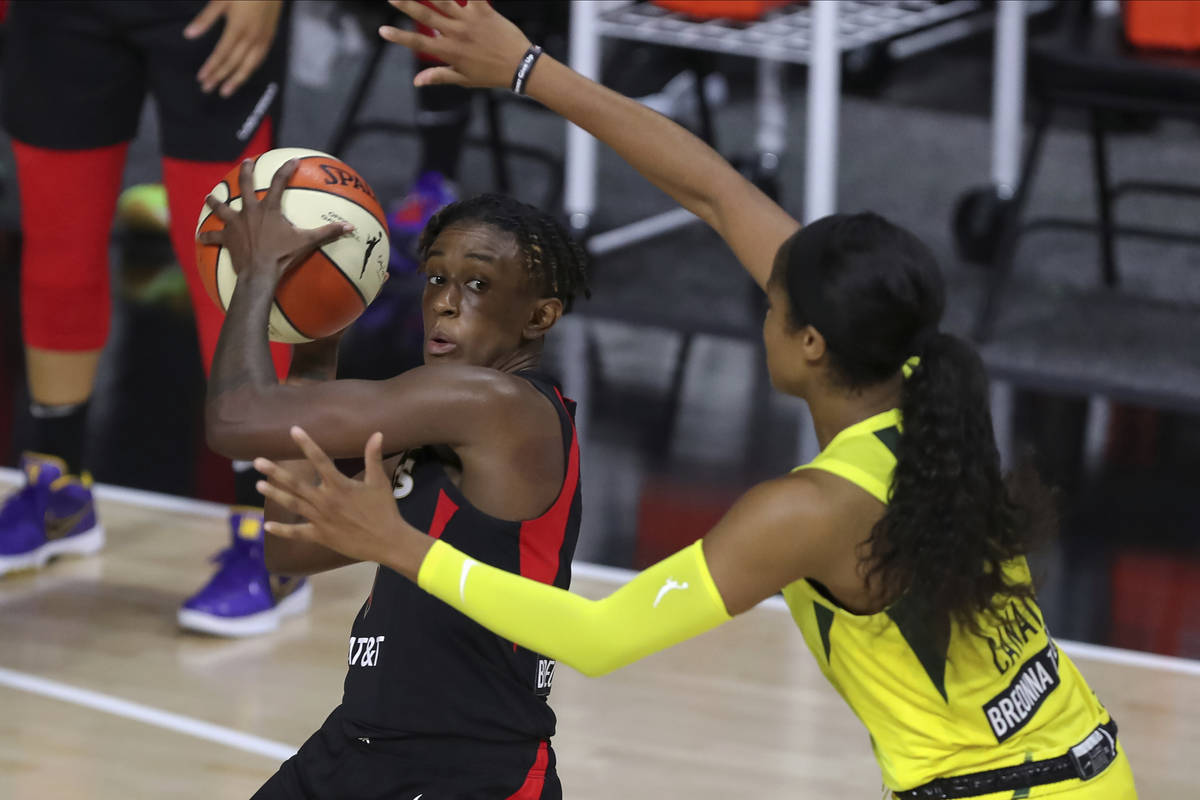 Las Vegas Aces' Danielle Robinson, left, looks to pass through the defense of Seattle Storm's J ...