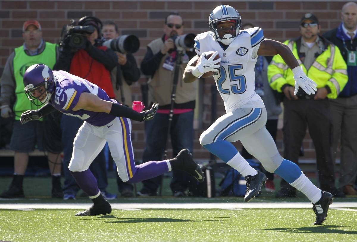 Detroit Lions running back Theo Riddick is chased by Minnesota Vikings free safety Harrison Smi ...