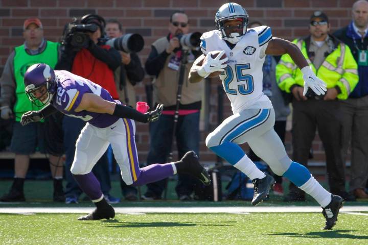 Detroit Lions running back Theo Riddick is chased by Minnesota Vikings free safety Harrison Smi ...