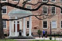 People remove belongings on campus at the University of North Carolina in Chapel Hill, N.C., am ...