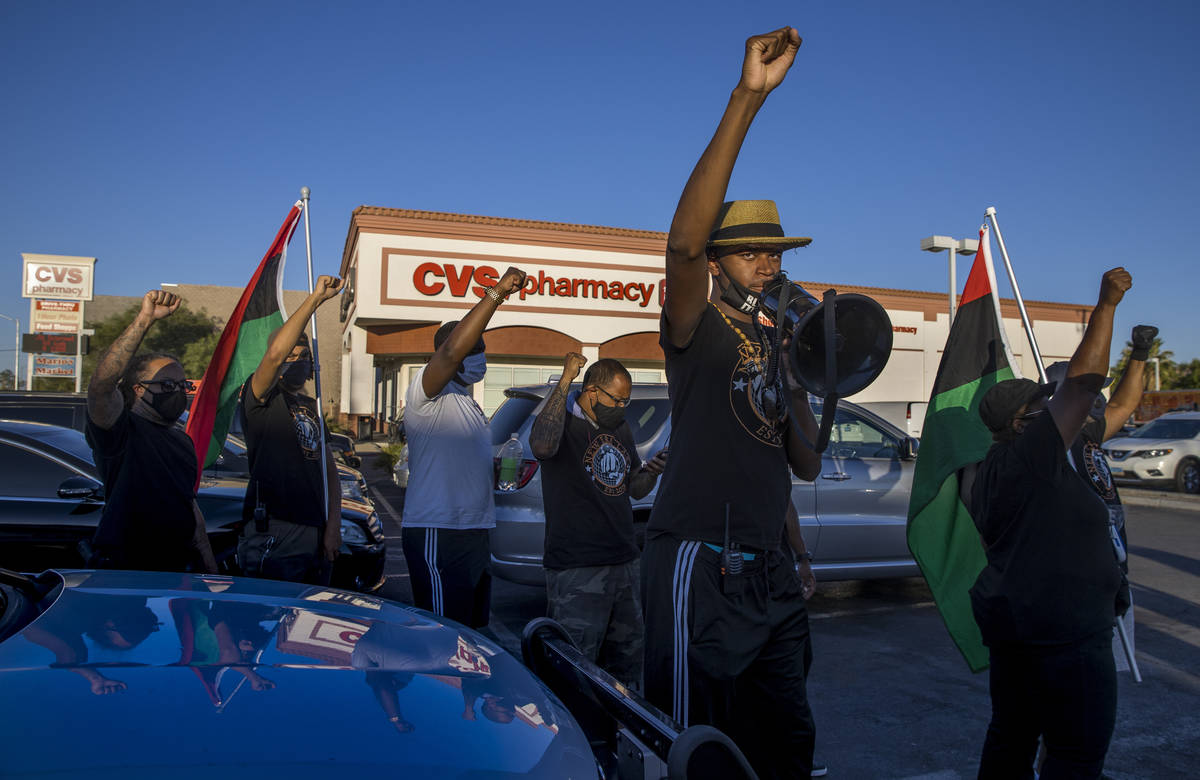 Minister Vance "Stretch" Sanders, founder and president of New Era Las Vegas, center, stands in ...