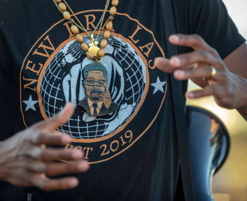 A pendant of Malcolm X hangs on the neck ofʭinister Vance "Stretch" Sanders, pr ...
