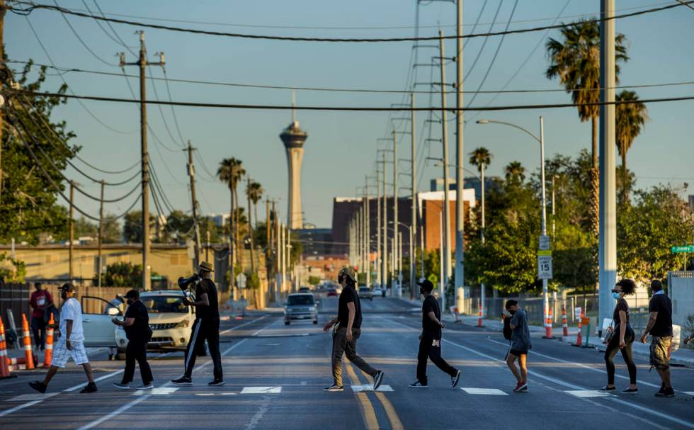 New Era Las Vegas members march across J Street late in the day during another Streetz Is Watch ...