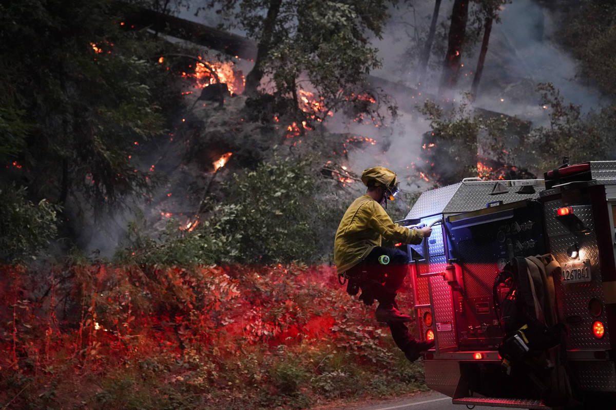 Ben Slaughter, a firefighter for the Boulder Creek Fire Department, gets down from a fire truck ...