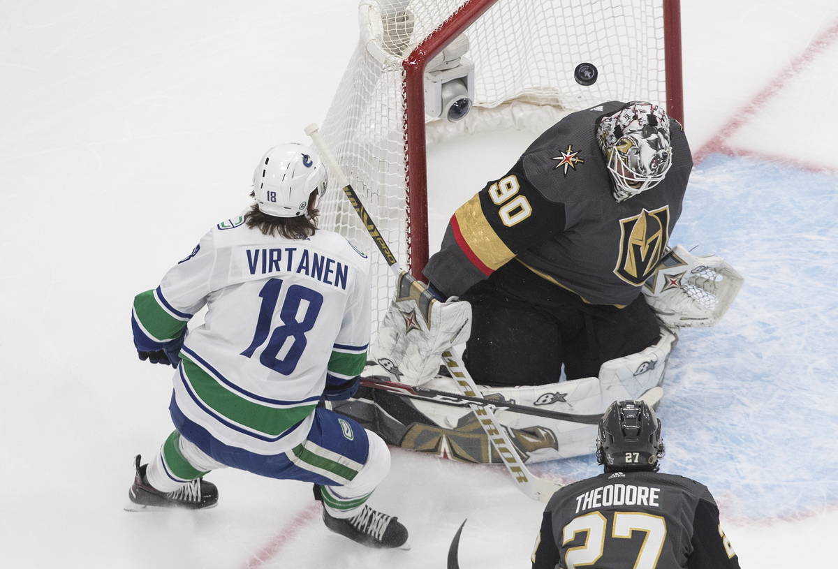Vegas Golden Knights goalie Robin Lehner (90) makes the save on Vancouver Canucks' Jake Virtane ...
