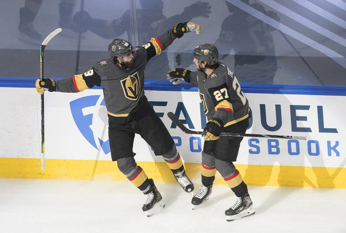 Vegas Golden Knights' Alex Tuch, left, and Shea Theodore (27) celebrate a goal against the Vanc ...