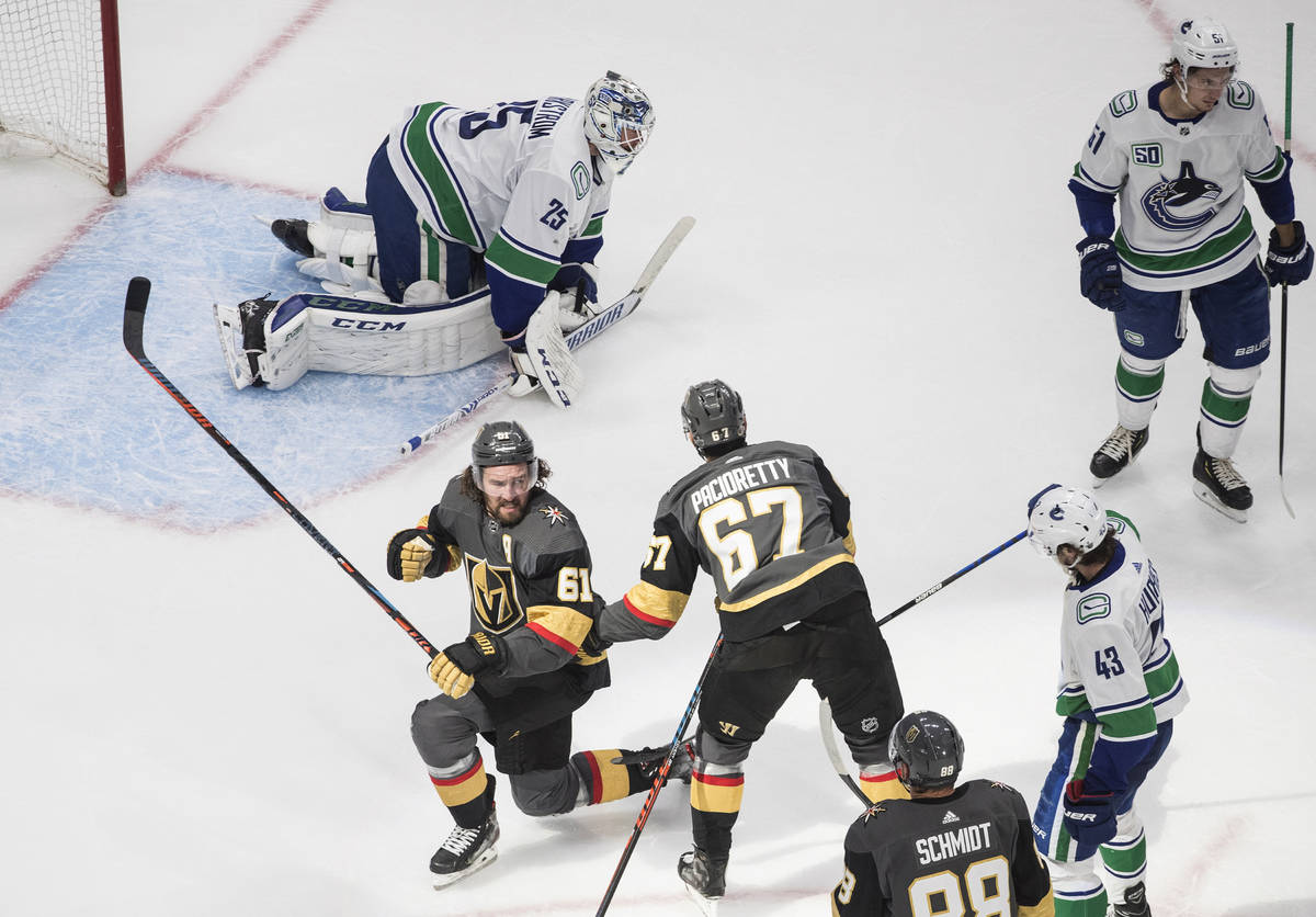 Vegas Golden Knights' Mark Stone (61) and Max Pacioretty (67) celebrate a goal on Vancouver Can ...