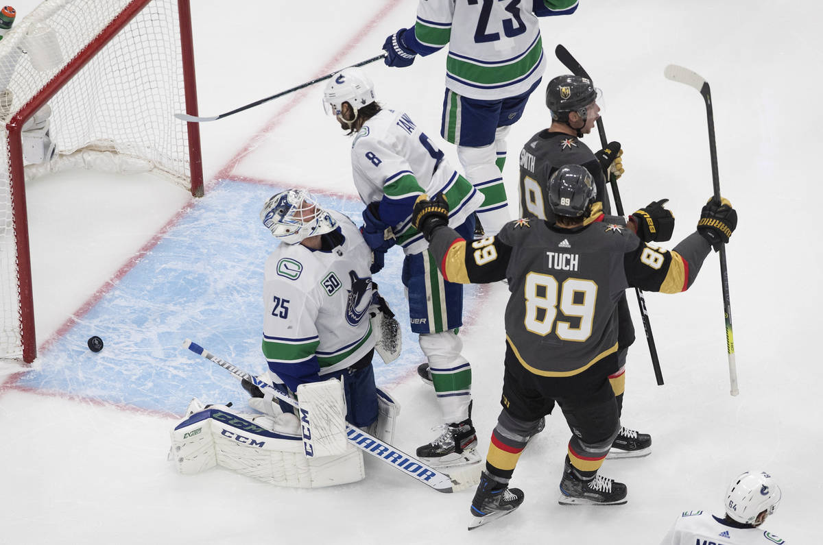 Vegas Golden Knights' Reilly Smith (19) and Alex Tuch (89) celebrate a goal as Vancouver Canuck ...