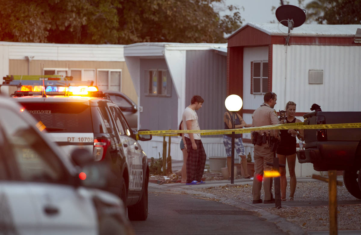 Metropolitan police speak to people at the Riviera Mobile Home Community where a homicide occur ...