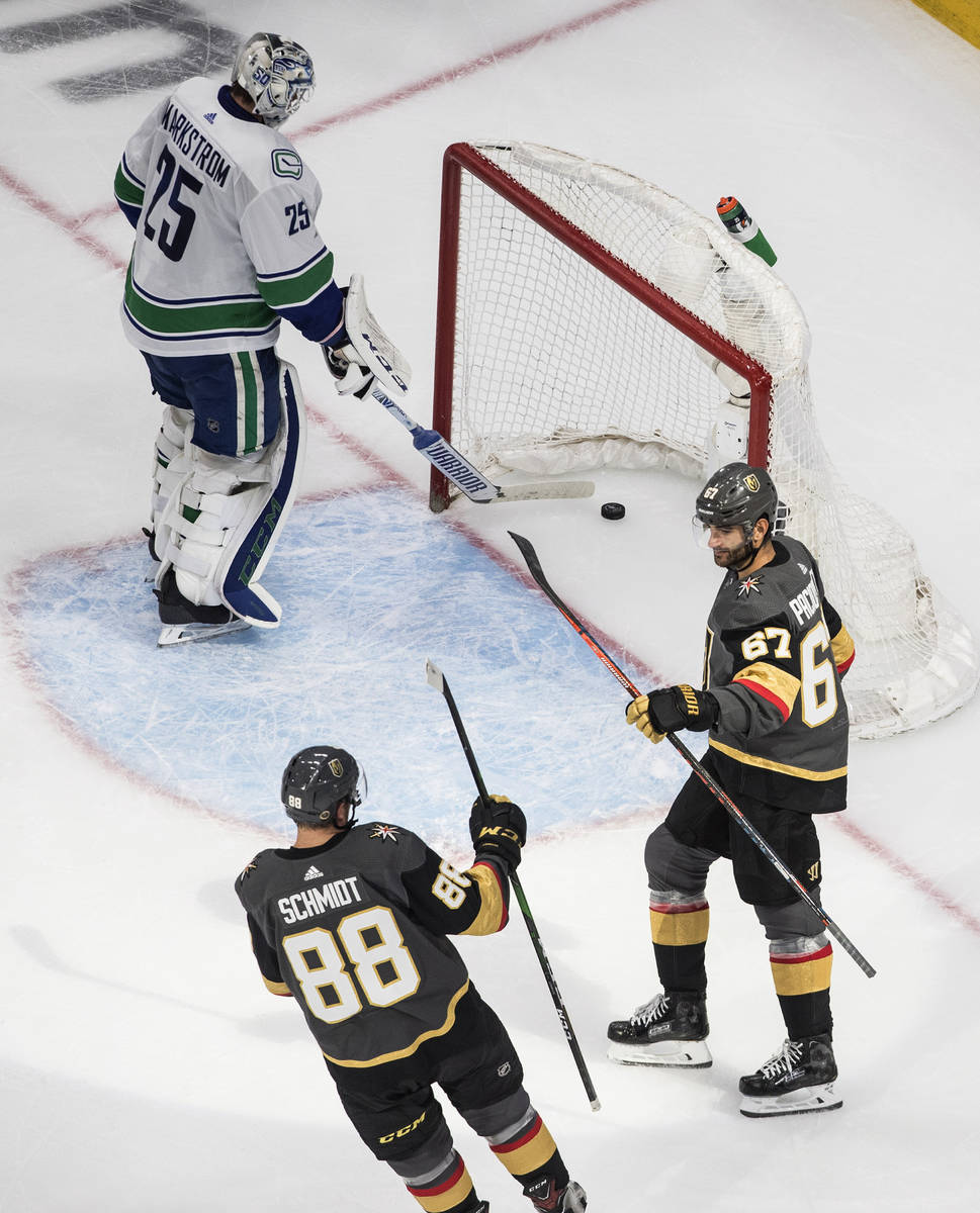 Vegas Golden Knights' Nate Schmidt (88) and Max Pacioretty (67) celebrate a goal on Vancouver C ...