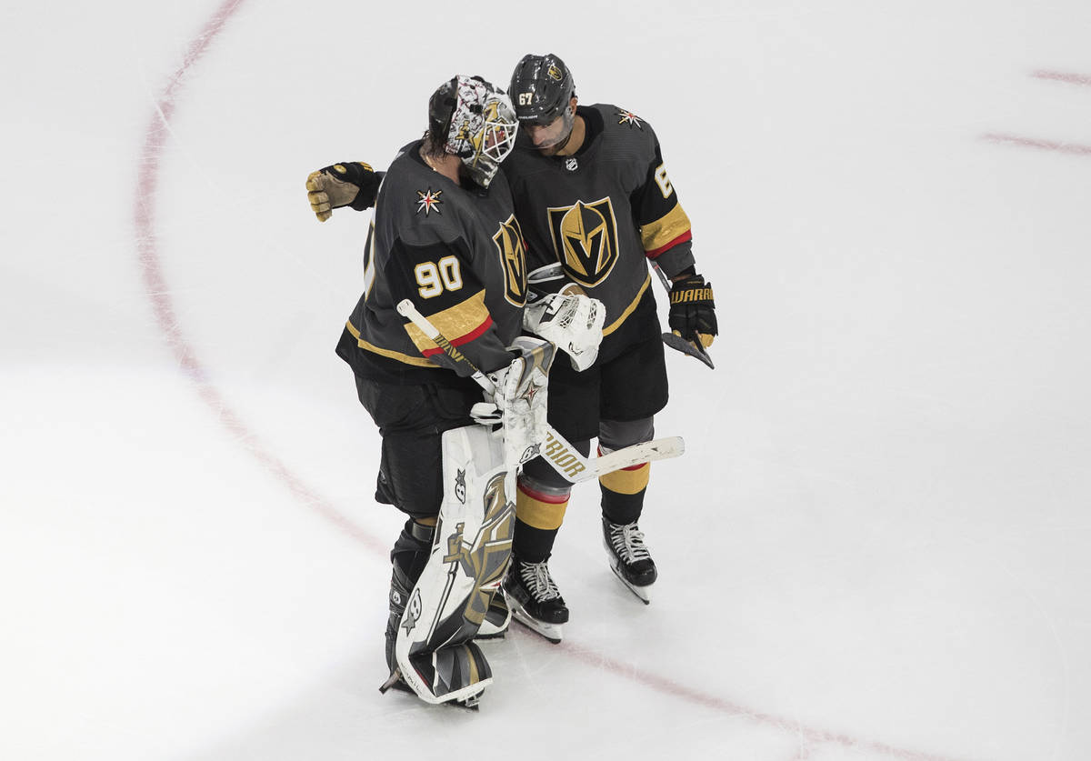 Vegas Golden Knights goalie Robin Lehner (90) and teammate Max Pacioretty (67) celebrate a win ...