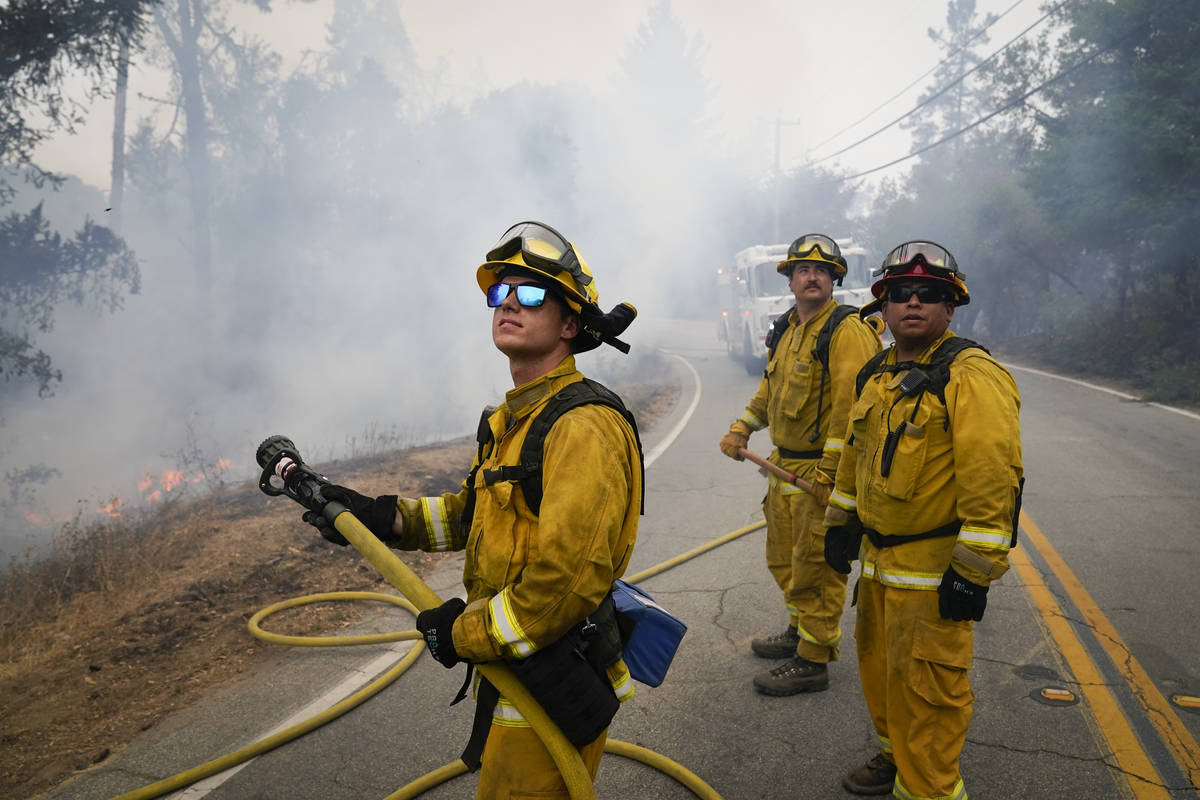 Firefighters Cody Nordstrom, Kyle Harp and Robert Gonzalez, from left, of the North Central Fir ...