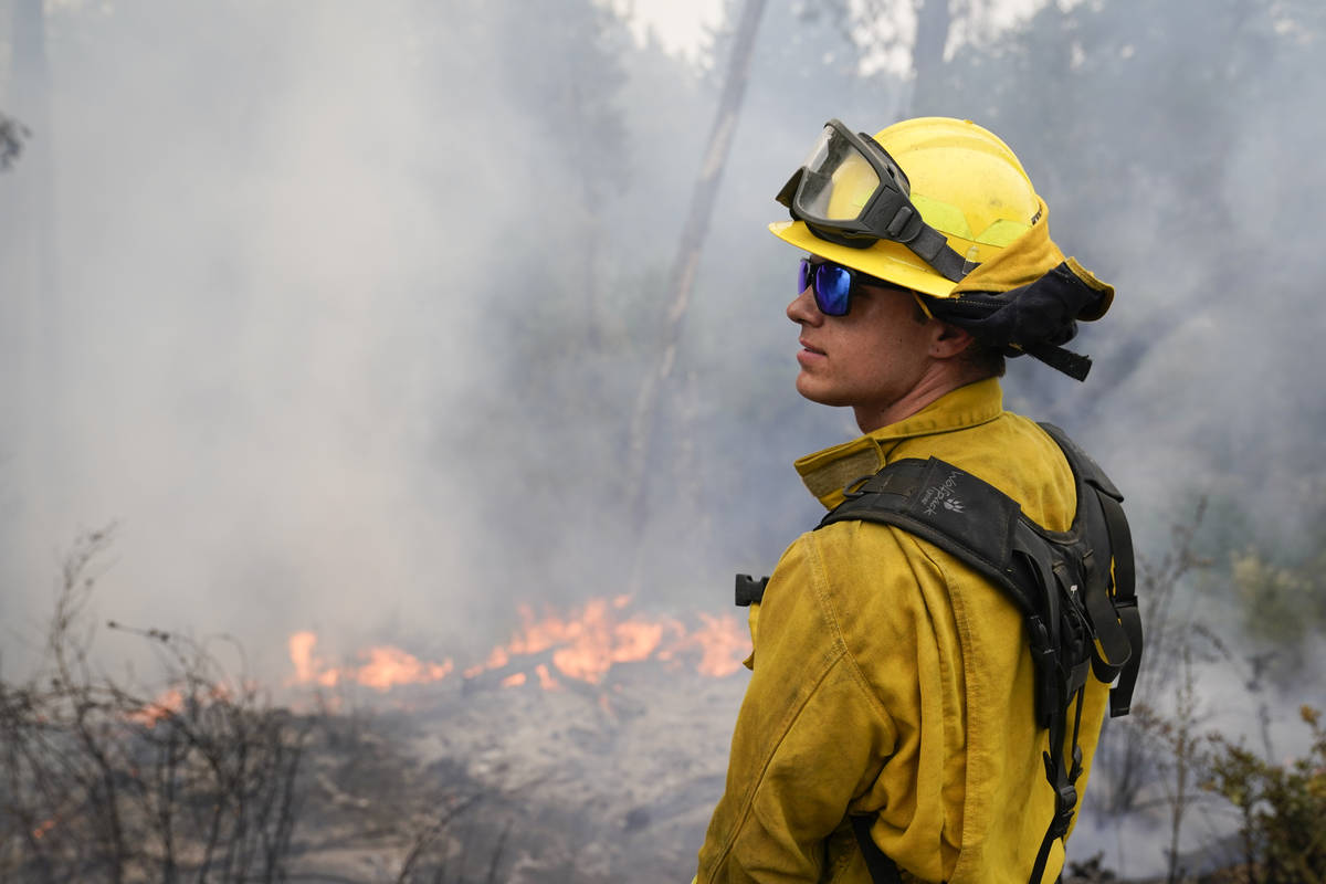 Firefighter Cody Nordstrom, of the North Central Fire station out of Kerman, Calif., monitors h ...